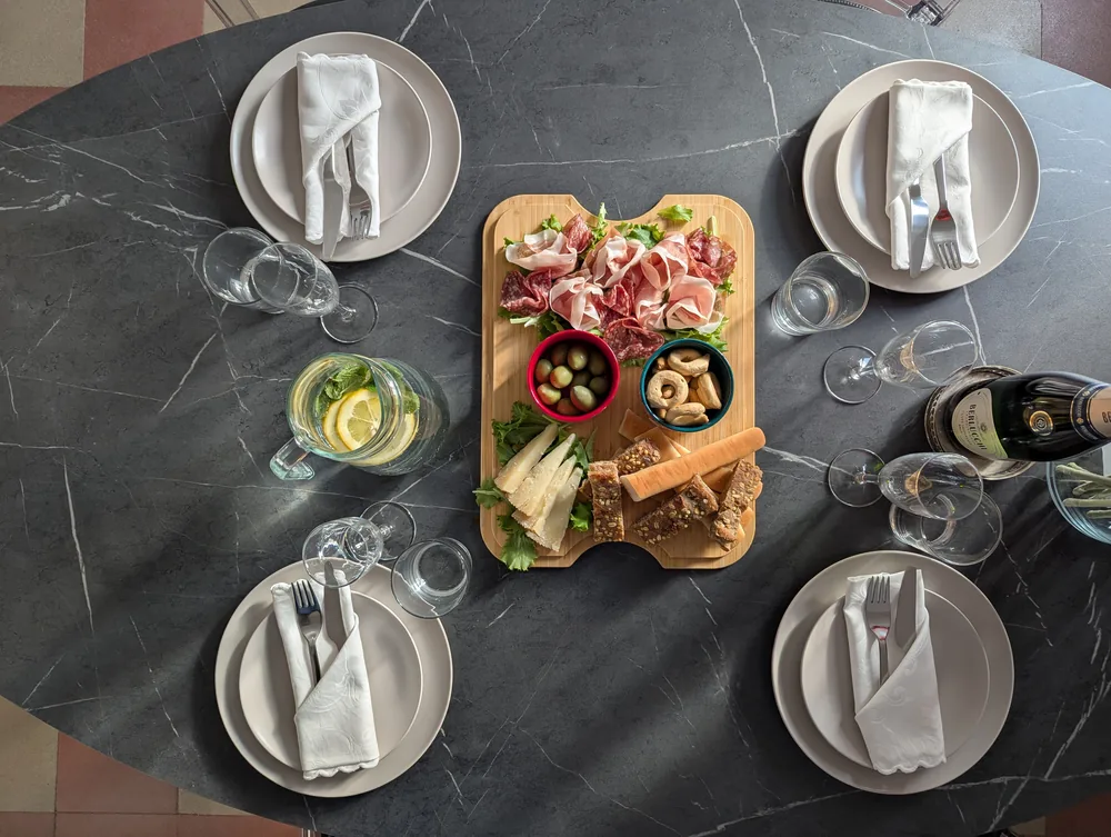 Tavolo da pranzo apparecchiato accanto alla cucina all’Ostiense 353 Apartment