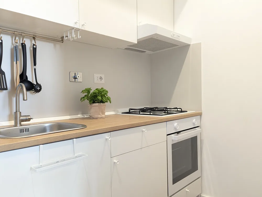 Cucina completamente attrezzata con forno e macchina del caffè all’Ostiense 353 Apartment